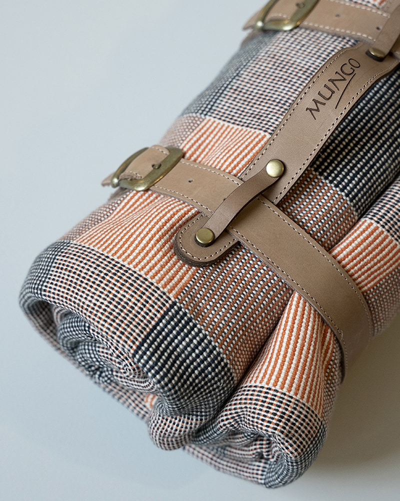 Mungo Picnic Blanket. With matching leather strap for compact carrying. Designed, woven, made at the Mungo Mill in Plettenberg Bay